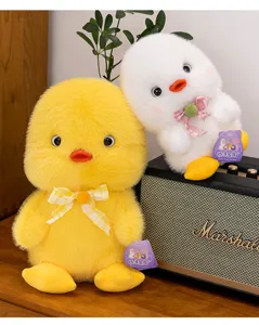 Close-up of cute yellow and white orange duck plush toys on a Marshall speaker.