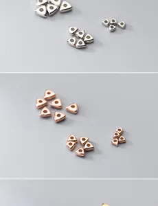 Close-up of silver and rose gold triangular spacer beads for DIY jewelry making projects