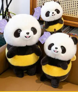Set of three cute panda plushies dressed as bees with fuzzy fur and yellow stripes on a sofa