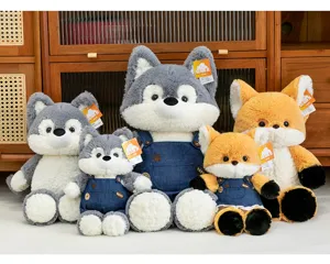 Adorable soft plush fox and wolf stuffed toys wearing denim overalls for children.
