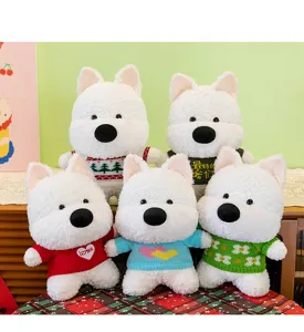 Detail view of five white Westie dog plush toys wearing diverse colorful knit sweaters