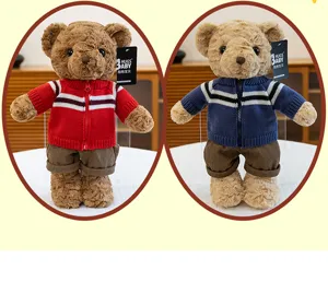 Close-up detail of cute plush teddy bear toy wearing knitted sweater and shorts.