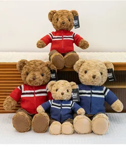 Cute plush teddy bear toy with knitted jacket, detailed view of lovely soft stuffed animal doll.