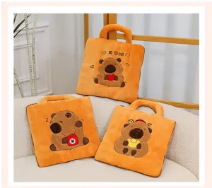 Set of three orange capybara plush pillows displayed on a cozy cream-colored sofa.