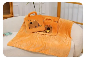 Macro view of orange capybara plush blanket pillow with soft fleece texture and handle