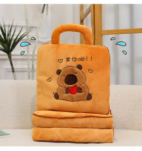 Detailed view of the cute Capybara plush pillow with embroidered heart and soft orange blanket