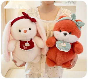 Cute plush rabbit and fox stuffed animals wearing decorative bibs and bow ties