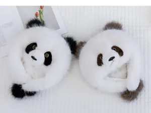 Detailed close-up view of two fluffy panda plush earflap hats on a white soft surface.