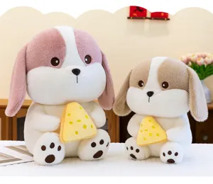 Detailed view of two plush puppy dogs holding yellow cheese slices in a warm room