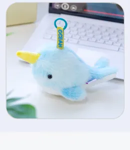 Macro view of light blue plush narwhal keychain accessory with soft faux fur texture