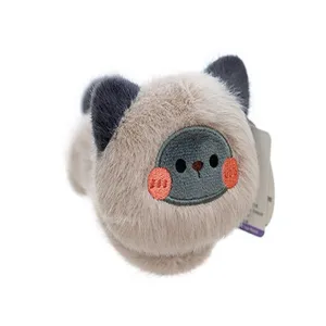 Close-up detail of cute magnetic Siamese cat plush toy with red blush embroidery