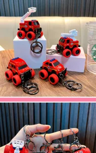 Detail macro view of multiple red fire truck and off-road vehicle keychain toy models on desk