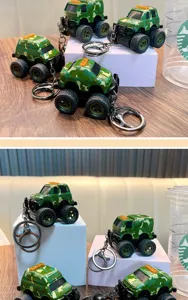 Detailed macro view of camouflage military monster truck toy keychains on white stands