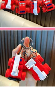 Detailed view of a mini red fire truck keychain with realistic ladder and wheels