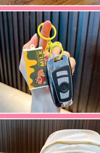 Close-up view of a chocolate milk capybara stress relief keychain attached to a car key