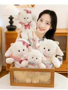Detailed view of multiple cute white lamb plush toys held by a model in a cozy setting