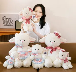 Group of cute plush sheep dolls in various sizes held by a girl in a home setting