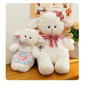 Pair of soft white sheep plush toys wearing cute sailor outfits and aprons on a table