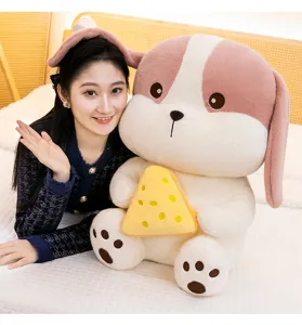 Soft plush dog toy holding a yellow cheese slice for kids, warm home setting.
