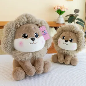 Two cute lion plush toys of different sizes displayed on a white table in a cozy home setting