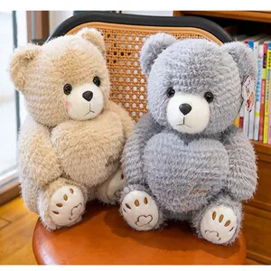 Close-up of cute beige and grey plush teddy bears with heart detail