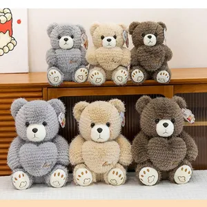 Six plush teddy bears holding hearts in grey, beige, and brown shown on a shelf