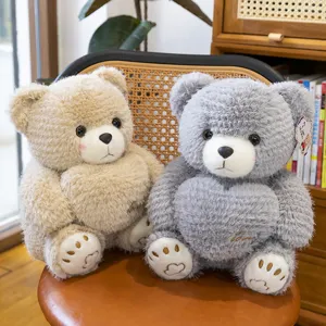Cozy sitting heart-shaped plush teddy bears in beige and gray colors for gift giving