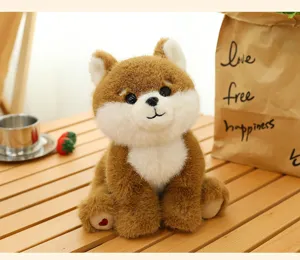 Close-up of a cute brown and white puppy plush toy sitting on a wooden table outdoors