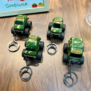 Four camouflage military monster truck toy keychains with large tires and sturdy metal rings