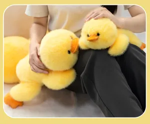 Soft and cuddly yellow duck plush toys in two sizes shown in a cozy home setting