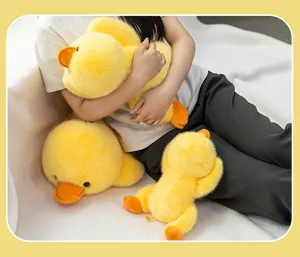 Close-up of cute yellow duck plush toy pillow held by a girl in a cozy indoor setting