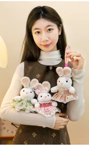 Macro view of plush rabbit dolls in colorful plaid dresses with delicate lace trim details