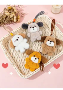 Close-up of four cute plush dog keychains with sad expressions in a basket