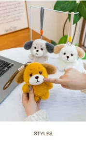 Close-up of three sad expression dog plush keychains with colorful ropes