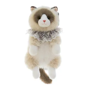 Macro view of plush Ragdoll cat doll with delicate lace collar and bow detail.