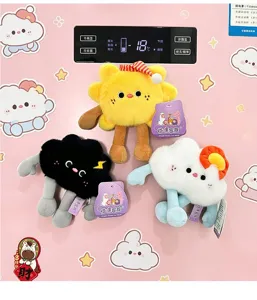 Detail view of cute plush weather series cloud magnets on a pink refrigerator