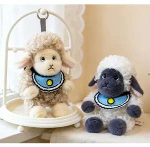 Detailed view of two cute curly sheep plush toys with blue bibs in a soft setting