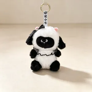 Cute black and white plush sheep doll keychain with a polka dot bow and lace collar detail