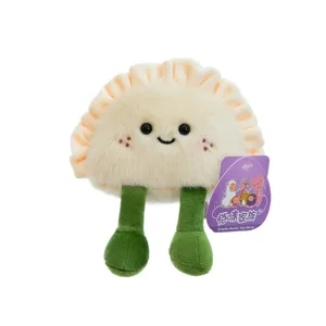 Cute smiling plush gyoza dumpling fridge magnet with green legs on white background
