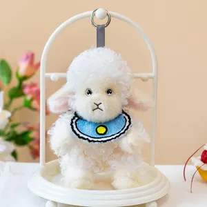 Cute white curly plush sheep pendant with blue bib on a white display stand