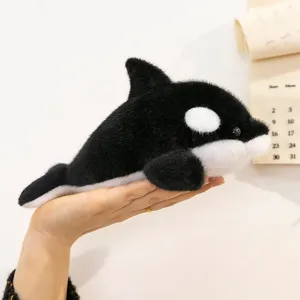 Adorable 8-inch black and white orca plush stuffed animal toy being held in a hand