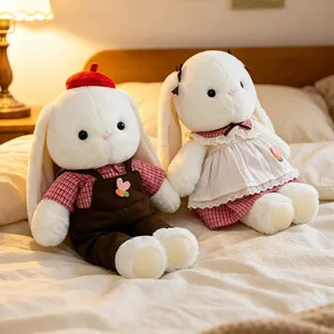 Pair of cute white plush rabbit dolls in adorable outfits for kids comfort gift