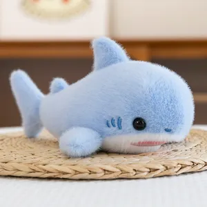 Cute 8-inch light blue shark plush toy with soft fur texture shown on a woven mat