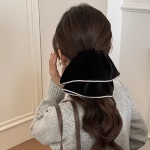 Elegant black velvet hair scrunchie with sparkling rhinestone trim for low ponytail