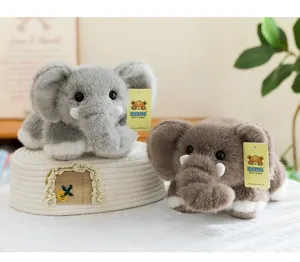 Soft grey and brown elephant plush toys lying on a decorative woven basket detail view