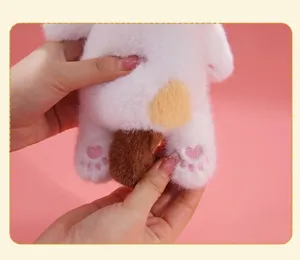 Close-up detail of calico cat plush toy showing soft fur and embroidered paw pads