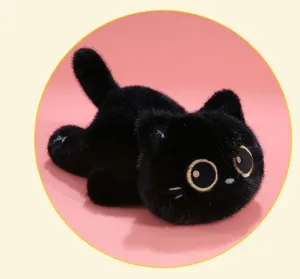 Detailed view of a cute black cat plush toy with big golden eyes in a lying pose