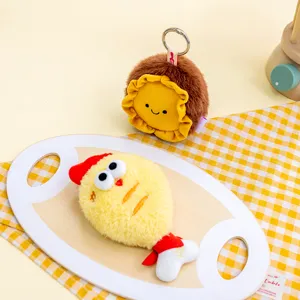 Close-up of cute plush cartoon keychains with fried chicken and smiley face designs