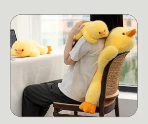 Lifestyle detail of a person holding a long yellow duck plush toy around their neck.
