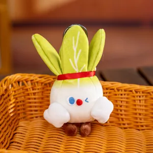 Close-up detail of a cute cartoon cabbage plush doll keychain resting in a basket